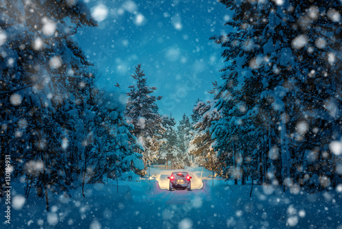 Obraz na płótnie Winter Driving at snowfall night - Lights of car in snowy road w salonie