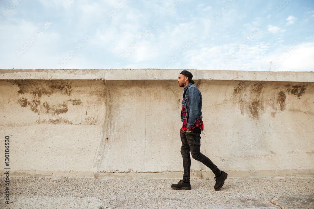 Handsome african young man walking on beach Handsome african young man walking on beach