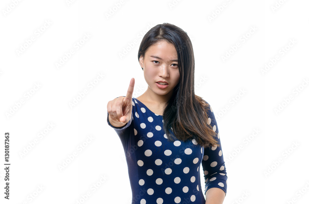 Angry stern young woman making a halt gesture Angry stern young woman making a halt gesture
