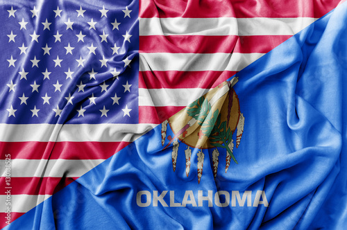 Ruffled waving United States of America and Oklahoma flag