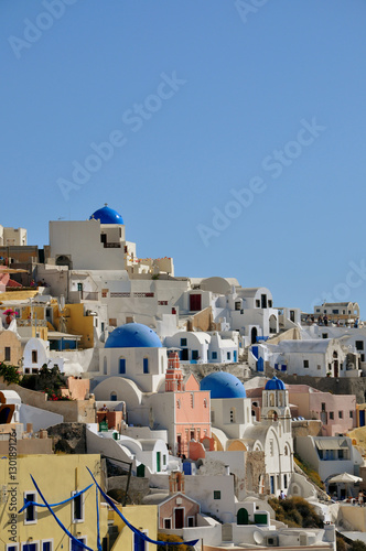 view to Santorini caldera, white houses and church domes at sunrise, Greece