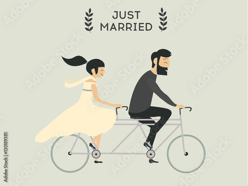Just married wedding couple riding bicycle

