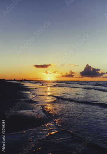 Vintage sunset over sea waves, Cloudy orange sunset over sea wat