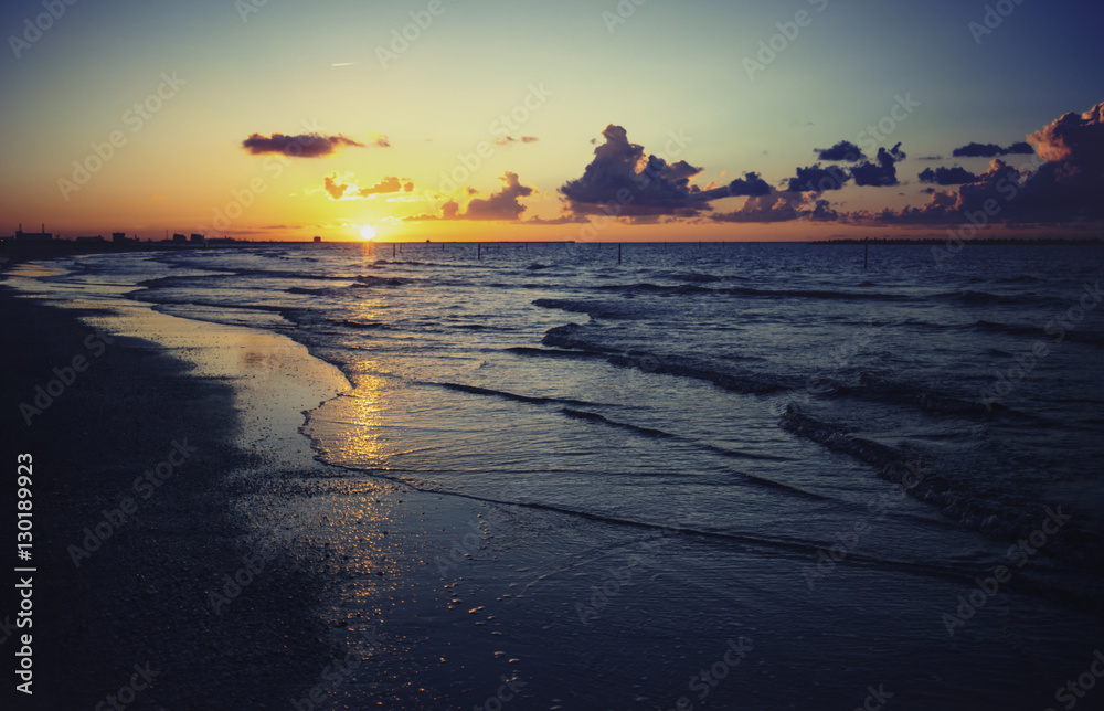 Vintage sunset over sea waves, Cloudy orange sunset over sea wat