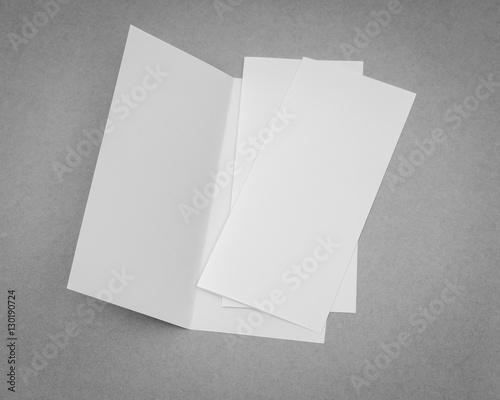 Bifold white template paper on gray background . © jannoon028