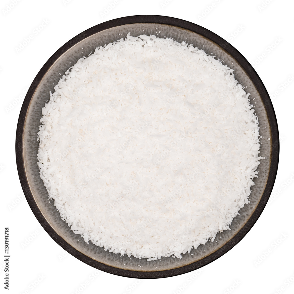 Organic grated coconut in ceramic bowl isolated on white background, top view Organic grated coconut in ceramic bowl isolated on white background, top view