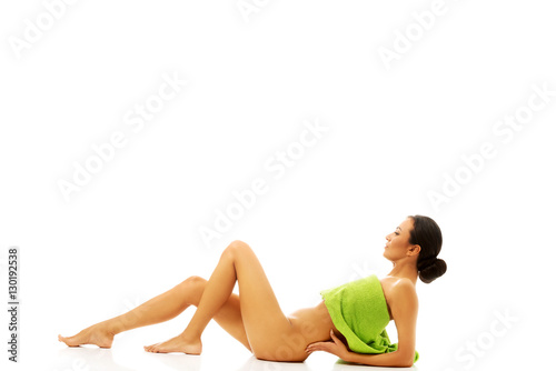 Woman lying wrapped in towel 