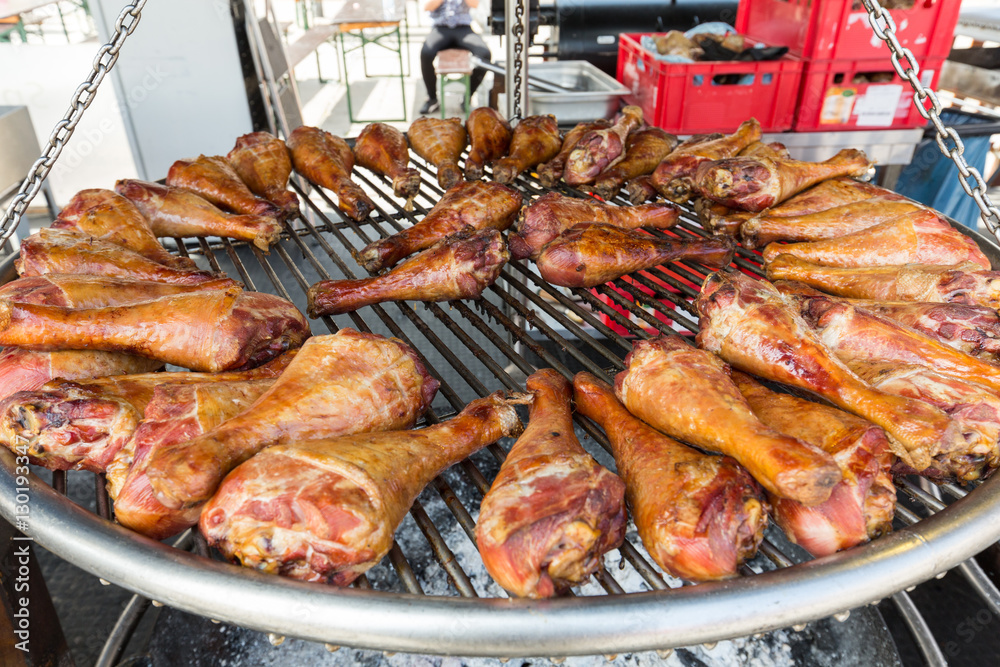 BBQ turkey legs on a large grill.