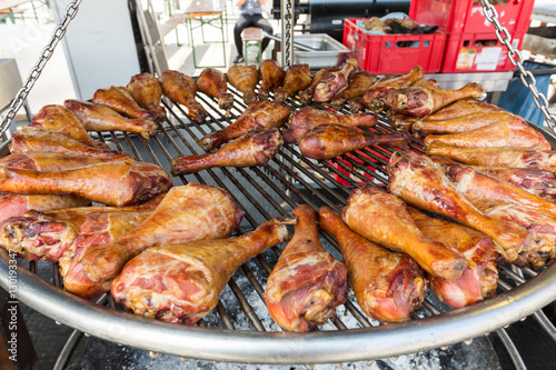 BBQ turkey legs on a large grill.