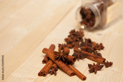 Wallpaper Mural seasoning cinnamon (Cinnamomum) and anise (Anisium vulgare Gaerto) lies on a light wood surface, spilled from a jar,  close-up, background, healthy lifestyle Torontodigital.ca
