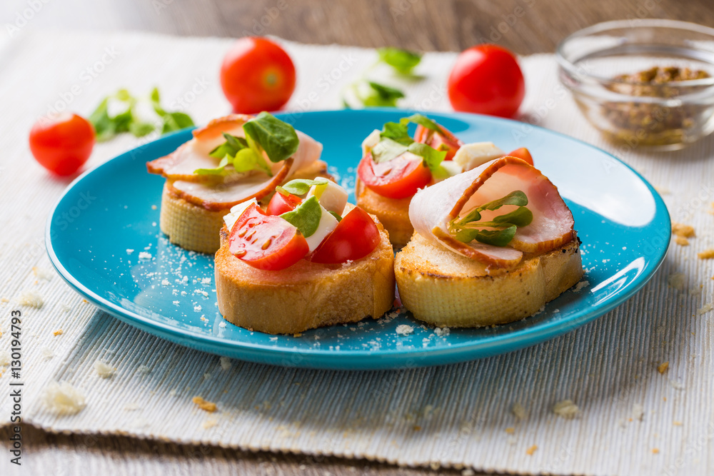 Bruschetta with tomato, cheese and bacon