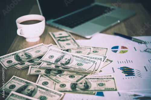 Working place of trader. The table covered by cash notes, keyboa