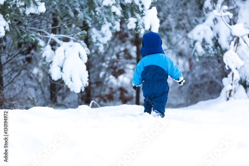 Happy caucasian child playing in snow