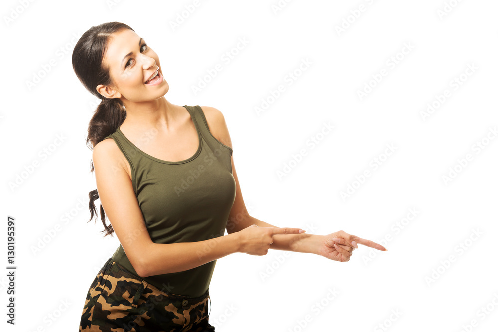 Woman in military clothes pointing to the right Woman in military clothes pointing to the right