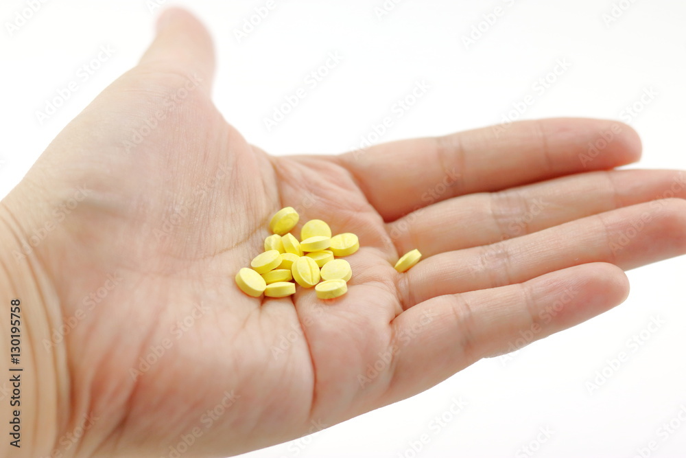 Yellow pill in hand. Yellow pill in hand.