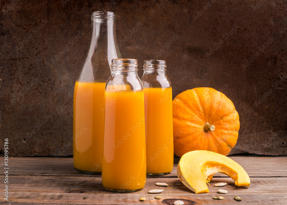 The fresh juice of ripe pumpkin bottled in various glass bottles The fresh juice of ripe pumpkin bottled in various glass bottles