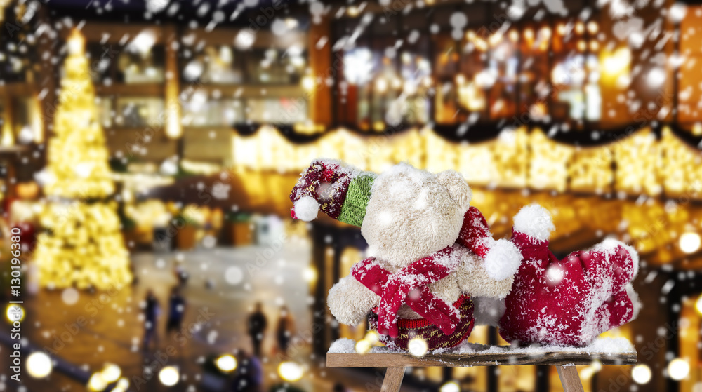 Couple teddy bear looking to light christmas decoration