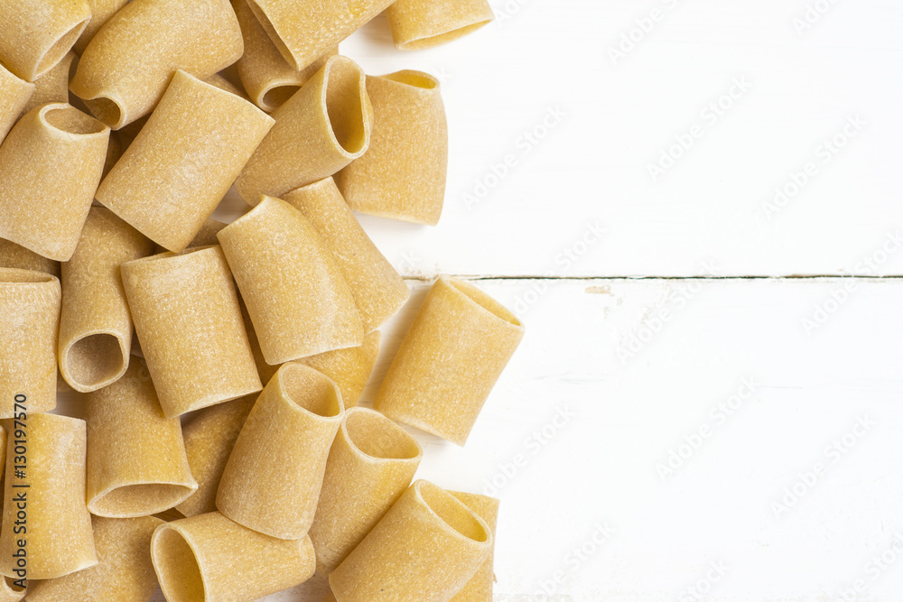 composition of raw Paccheri Pasta. Variety of Italian pasta in the shape of a very large tube. composition of raw Paccheri Pasta. Variety of Italian pasta in the shape of a very large tube.
