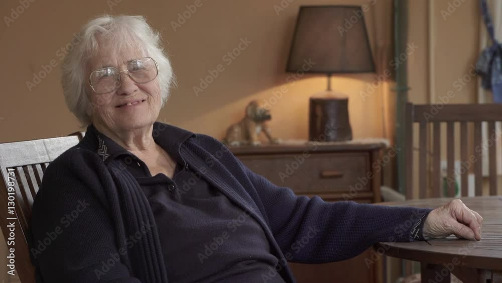 Old woman sitted smiling to the camera Old woman sitted smiling to the camera
