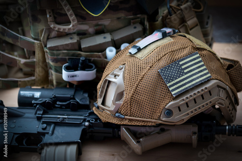 Bild auf Leinwand military equipment with a rifle on a wooden table