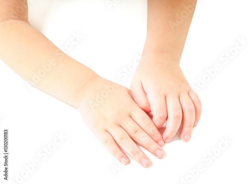 Toddler leaning towards on a white table  with hands together