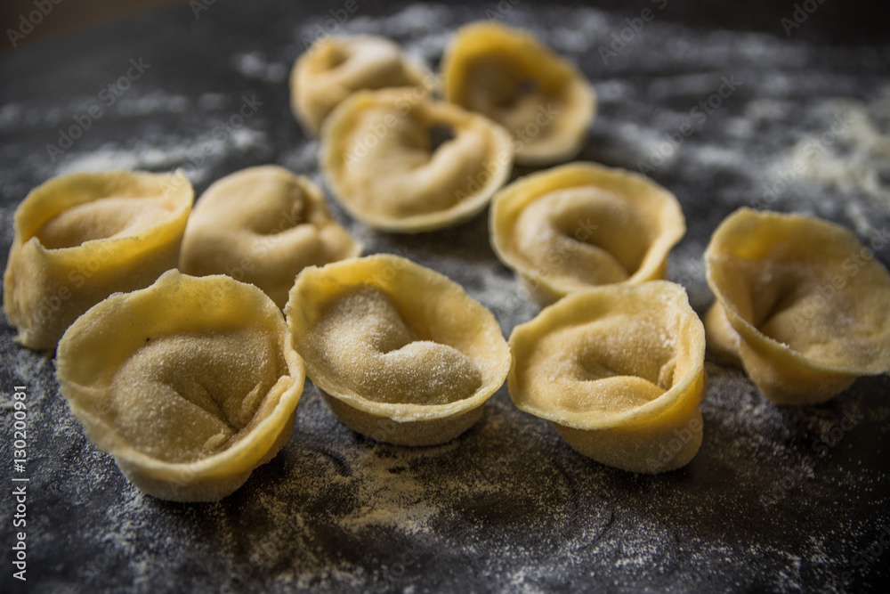 Making tortellini pasta from italian flour semolina, eggs, mushr