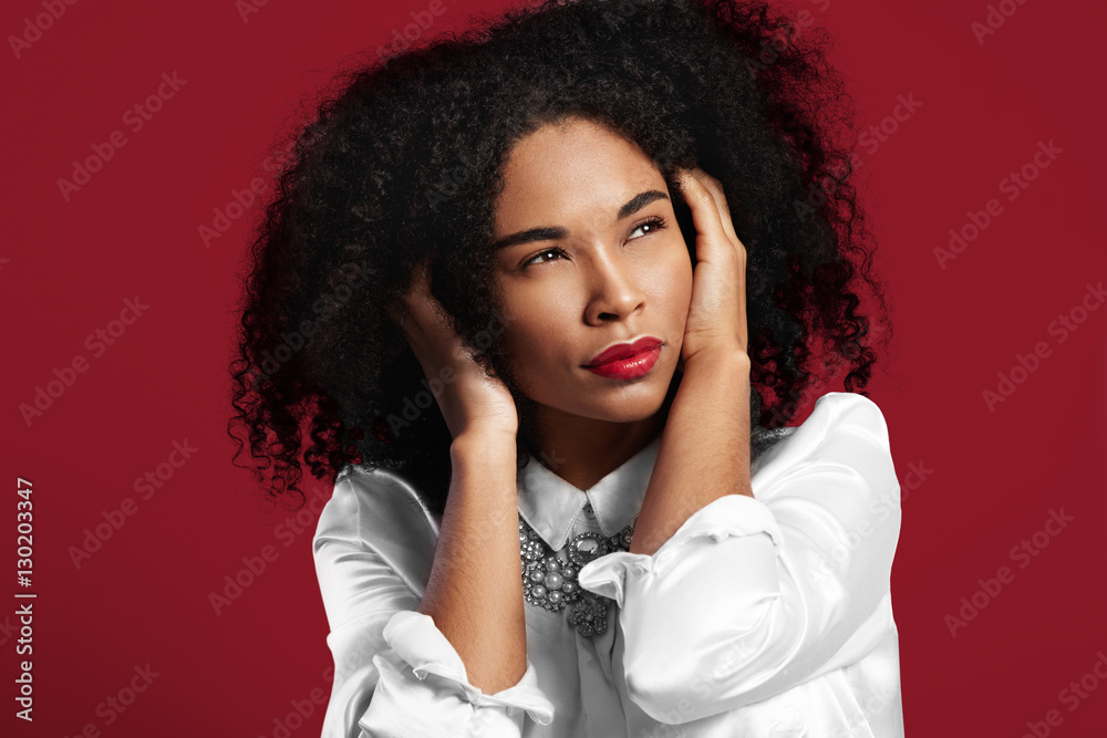 black woman closed her ears from high level sound on red backgro black woman closed her ears from high level sound on red backgro