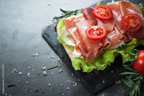 Ciabatta sandwich with salad leaves jamon serrano mozzarella