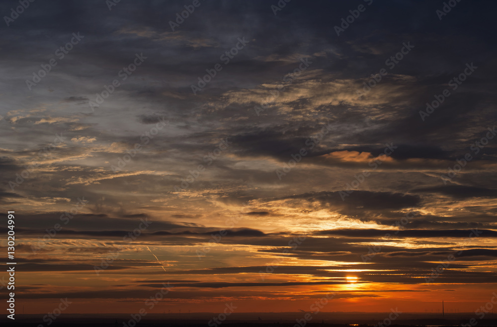 beautiful evening sky with dramatic clouds at sunset over the romantic horizon of Saxony in Germany