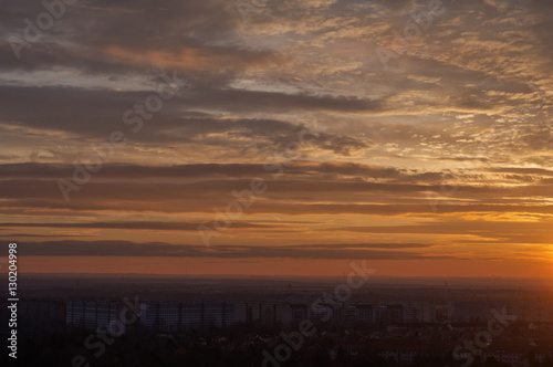 beautiful sunset in the dramatic cloudy sky over the residential district of L  snig in Leipzig  Germany