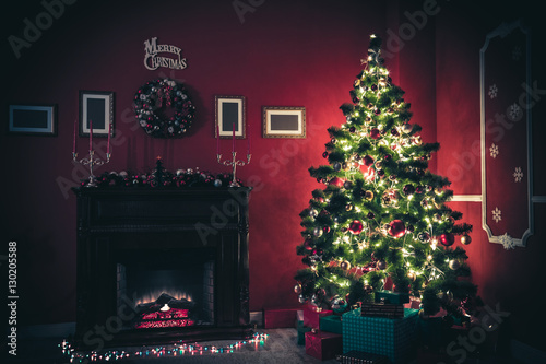 Beautiful Christmas living room with decorated Christmas tree  gifts and fireplace. The idea for postcards