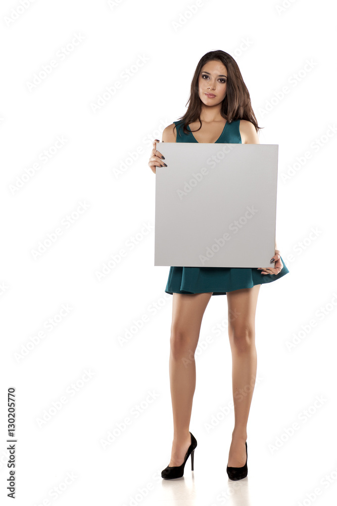 advertising young woman in a short turquoise dress holding empty banner advertising young woman in a short turquoise dress holding empty banner