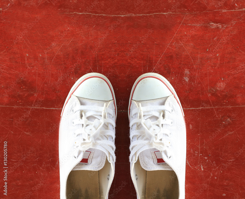 Pair of Sneakers on Wooden Floor.