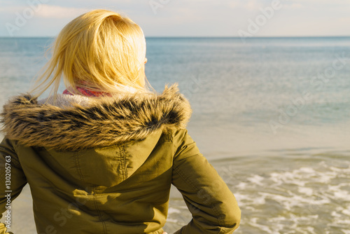 Woman relaxing on beach, cold day © anetlanda