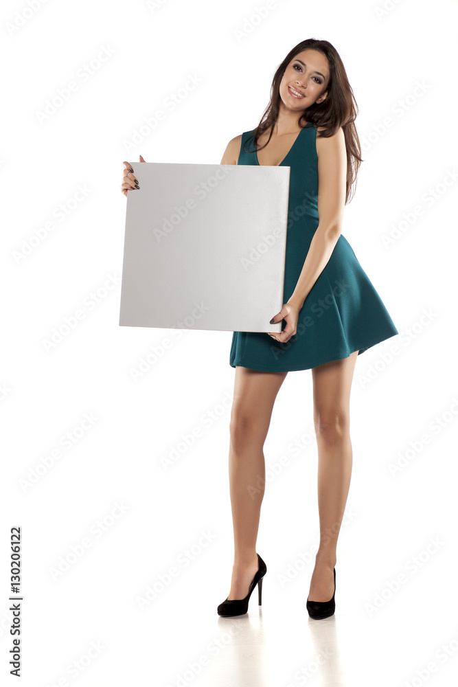 advertising young woman in a short turquoise dress holding empty banner advertising young woman in a short turquoise dress holding empty banner