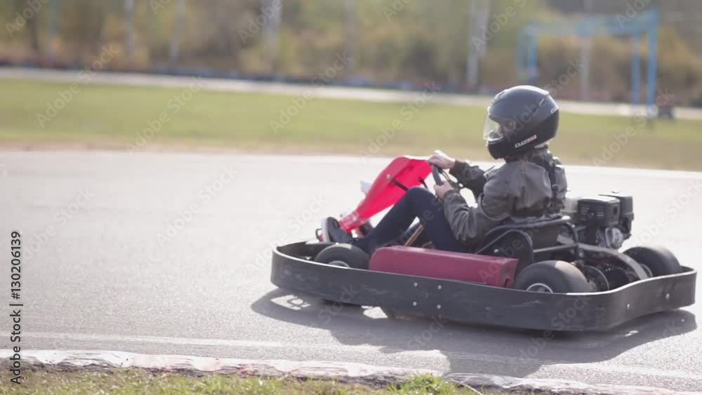 Go-kart track. Kart starts moving and slowly accelerates.