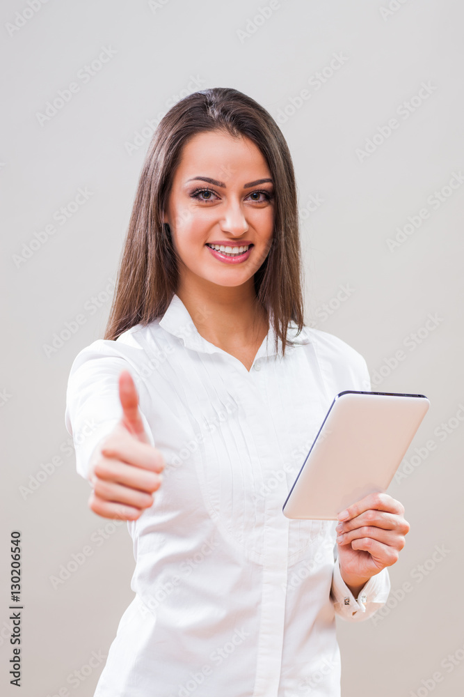 Studio shot portrait of young successful businesswoman who is using digital tablet. Studio shot portrait of young successful businesswoman who is using digital tablet.