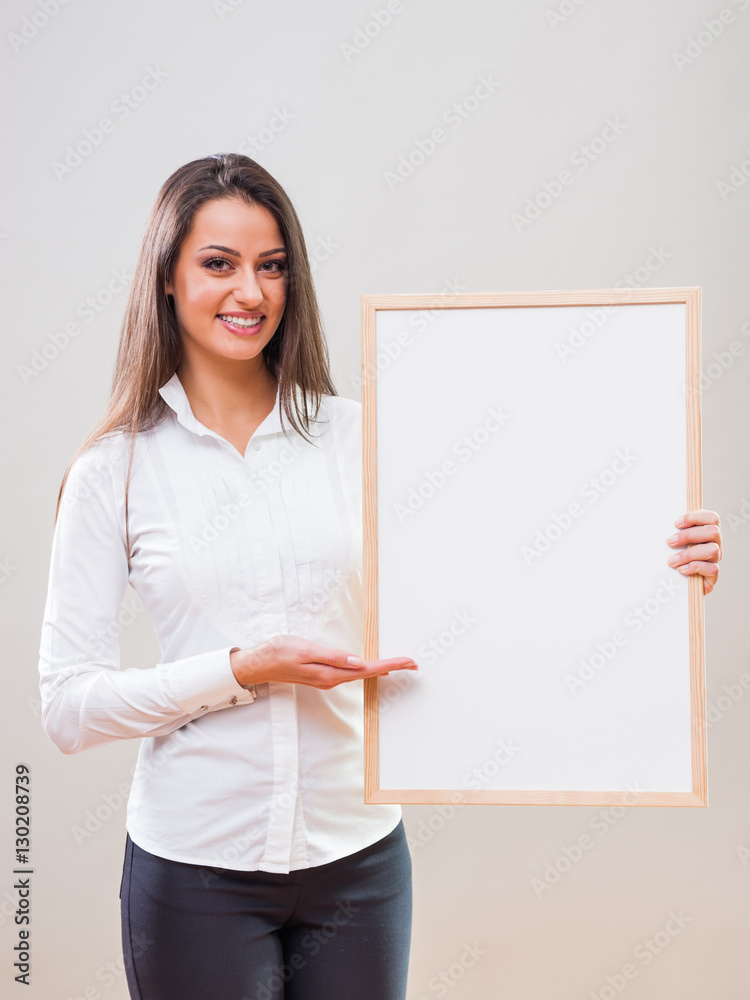 Portrait of businesswoman who is holding white table with blank space for your advertisement. Portrait of businesswoman who is holding white table with blank space for your advertisement.