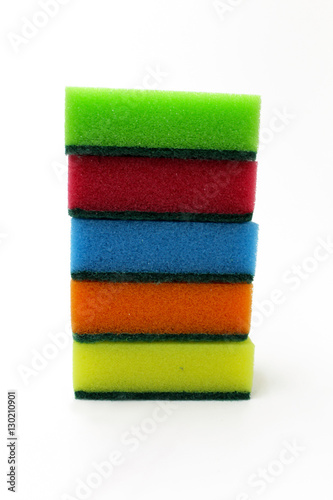 Multicolored sponges for washing dishes on a white background