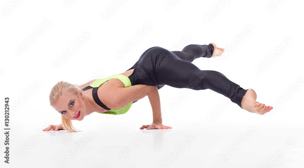 Attractive female gymnast exercising at studio