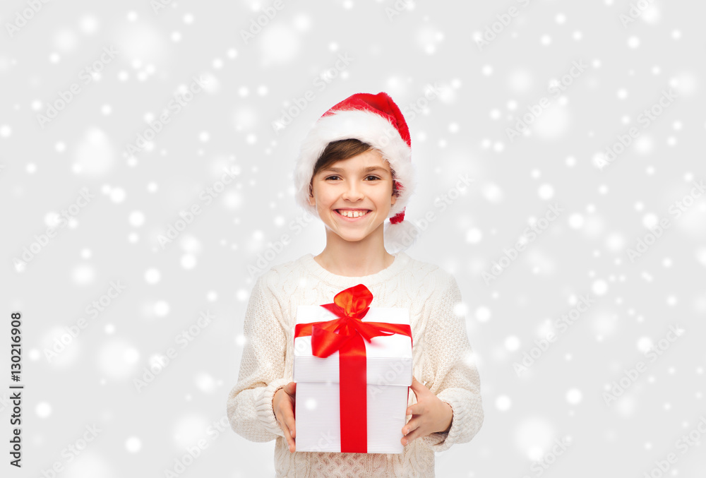 smiling happy boy in santa hat with gift box smiling happy boy in santa hat with gift box