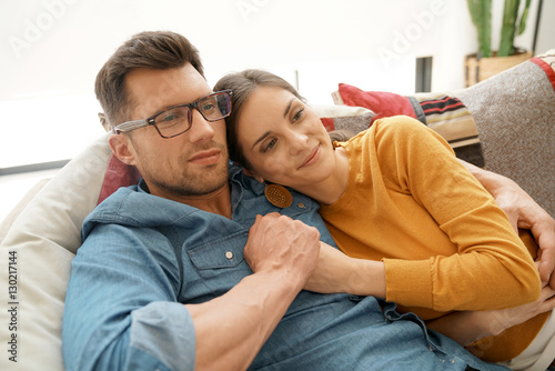 Couple home relaxing in sofa and watching tv