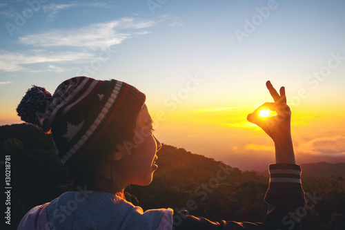 Silhouette Freedom woman standing with raised arms and enjoying