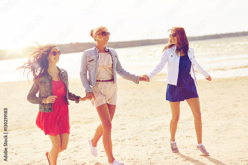 group of smiling women in sunglasses on beach group of smiling women in sunglasses on beach