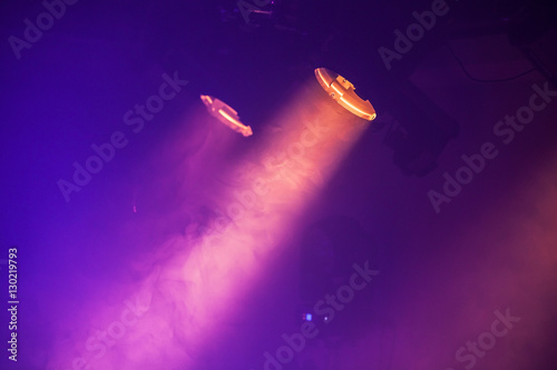Quadro em tela Spot lights with purple rays in the dark