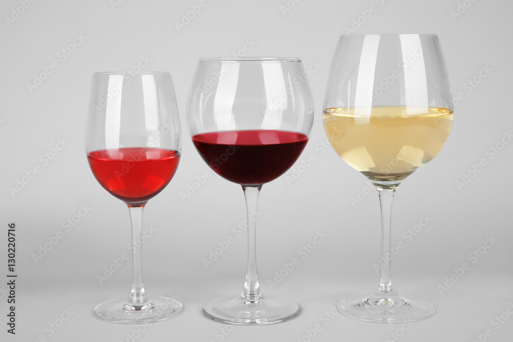 Three glasses with tasty wine on light background Three glasses with tasty wine on light background