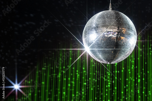 Disco ball with stars in nightclub with striped green and black walls lit by spotlight, party and nightlife entertainment industry