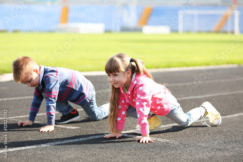 Little girl and boy in read...