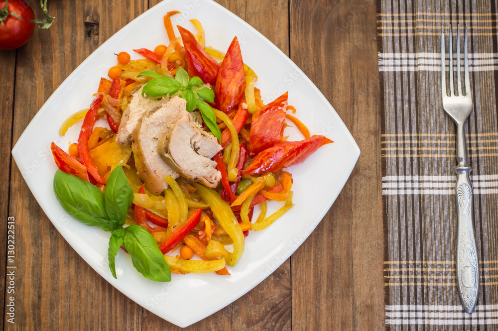 Roast duck breast with vegetable saute on a square plate. Wooden background. Top view. Close-up Roast duck breast with vegetable saute on a square plate. Wooden background. Top view. Close-up