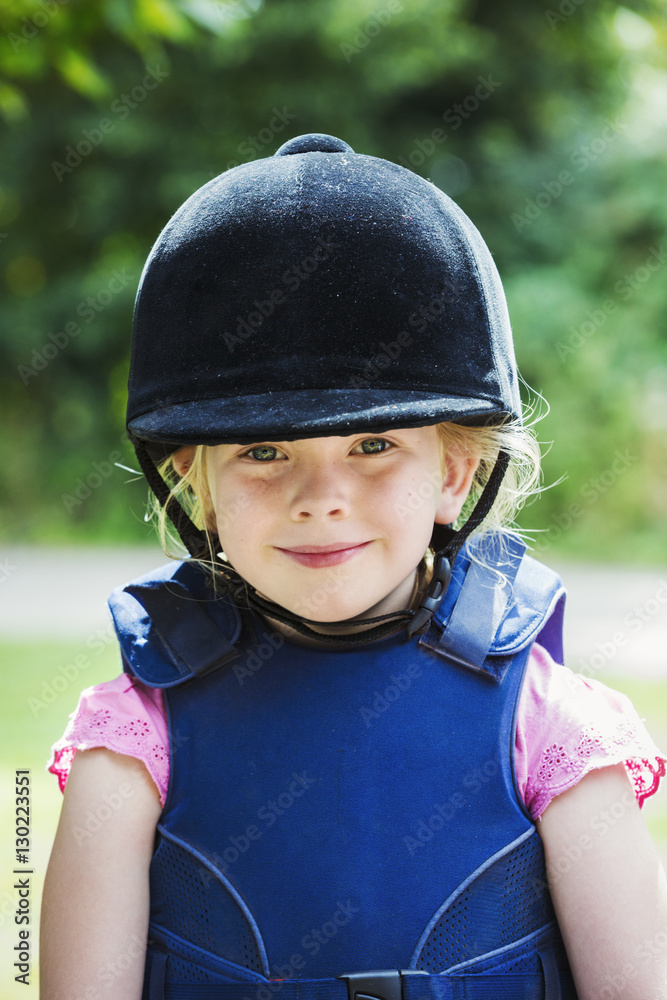 Portrait of blond girl wearing riding hat. Portrait of blond girl wearing riding hat.